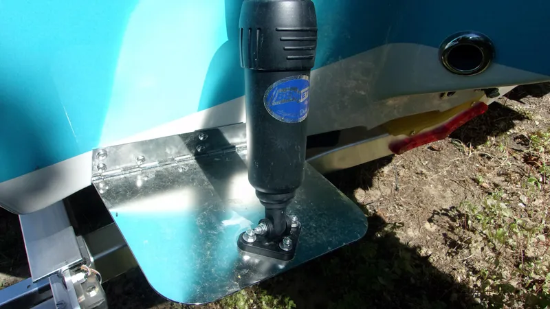 Slide: The Image of 2025 Key West 210 Bay Reef boat trim tab detail with blue hull. - 12