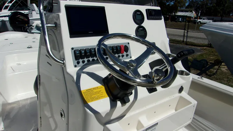 Slide: The Image of 2025 Key West 210 Bay Reef boat console with steering wheel and control panel. - 14