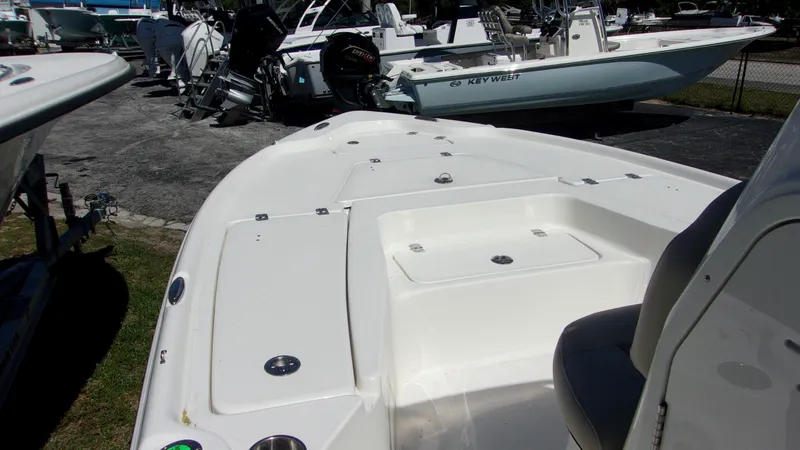 Slide: The Image of 2025 Key West 210 Bay Reef boat, white deck, parked outdoors. - 18