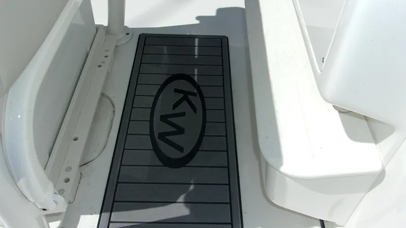 Slide: The Image of Key West 210 Bay Reef 2025 boat deck with KW logo mat. - 21