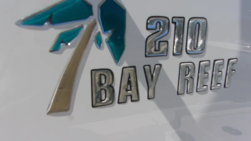 Slide: The Image of Key West 210 Bay Reef 2025 logo on boat exterior. - 23