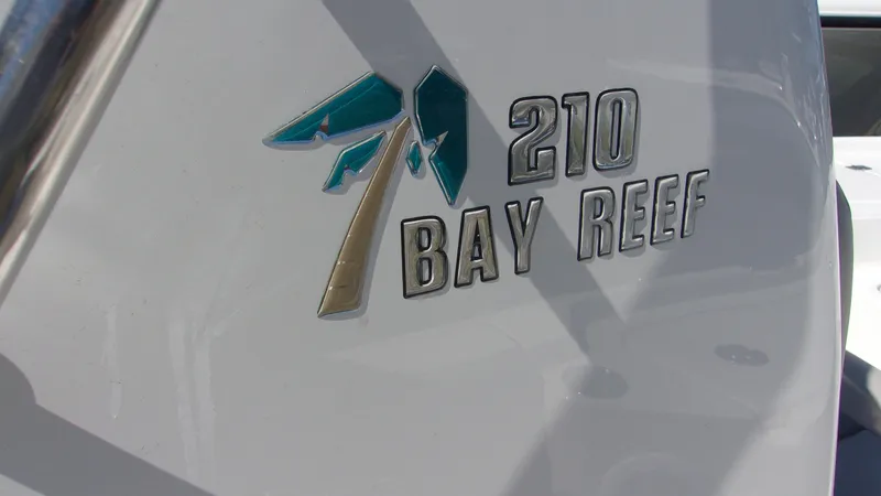 Slide: The Image of 2025 Key West 210 Bay Reef boat logo on white surface. - 24