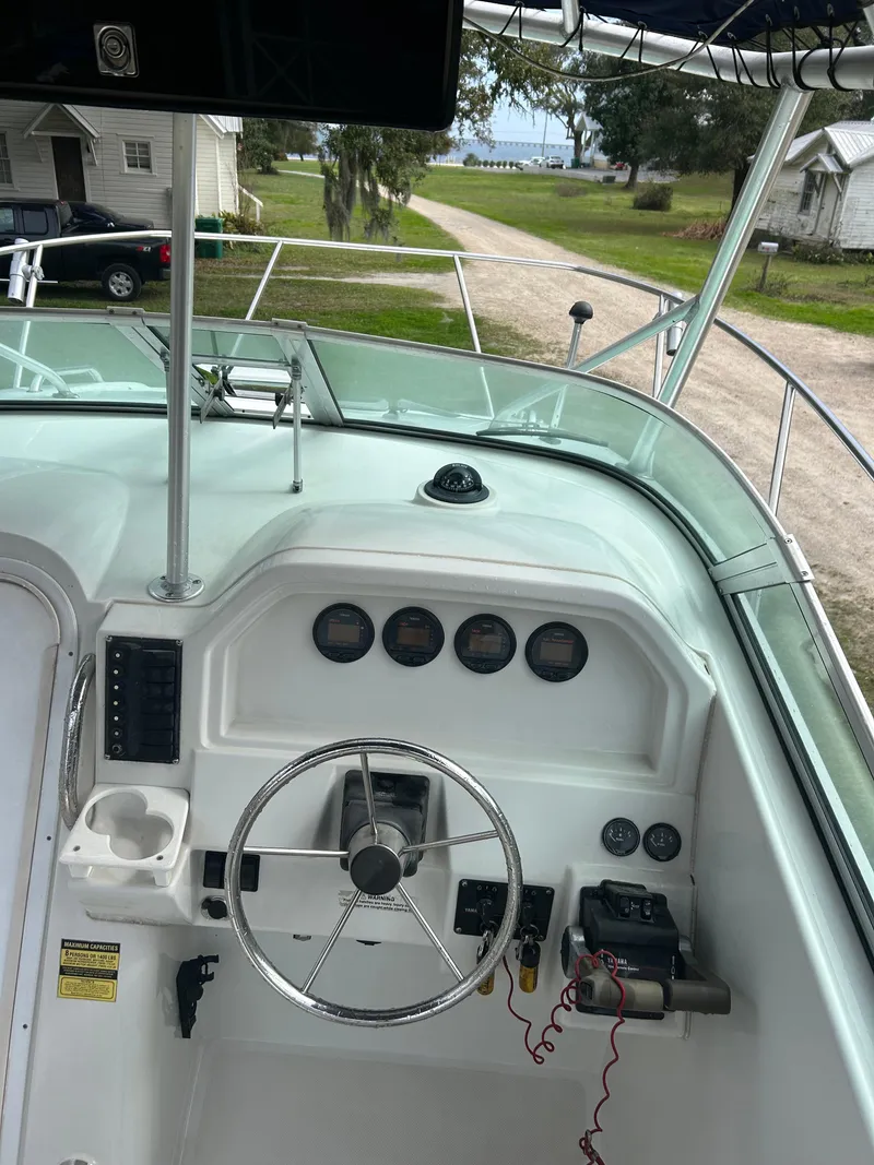 Slide: The Image of 2001 Glacier Bay Island Runner boat dashboard with steering wheel and gauges. - 11