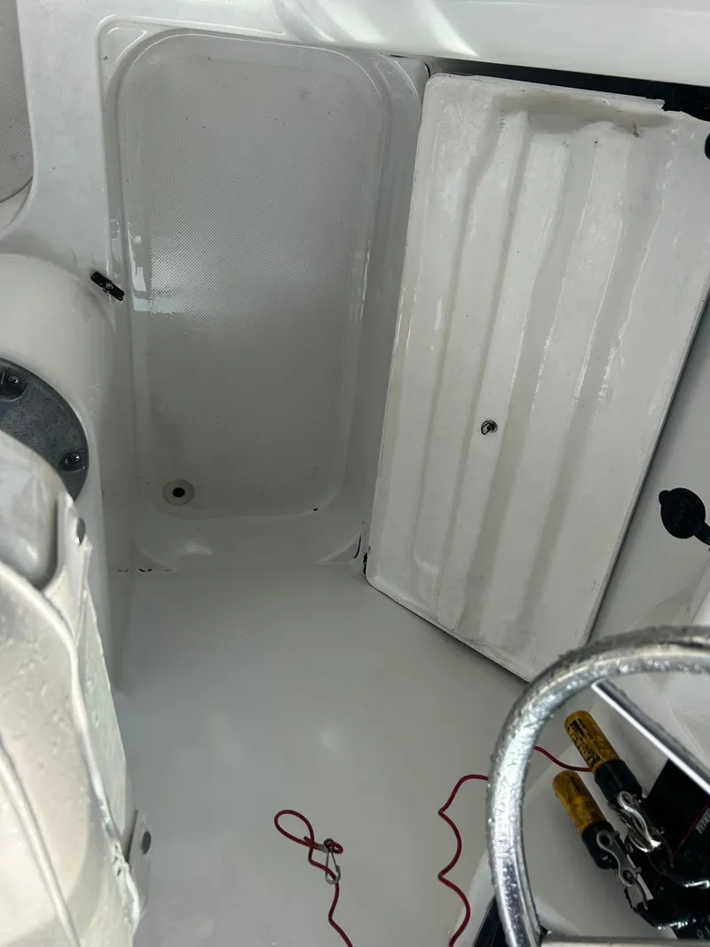 Slide: The Image of Interior of a 2001 Glacier Bay Island Runner boat, featuring a clean white cabin space. - 13