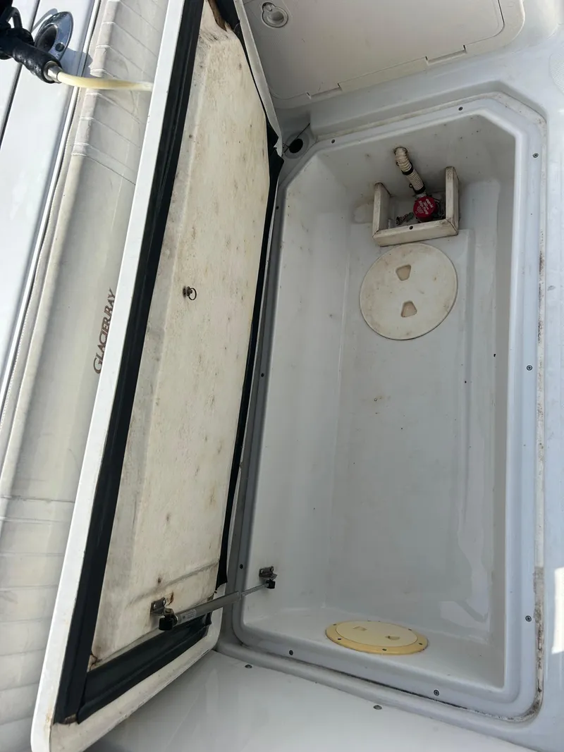 Slide: The Image of Open storage compartment in a 2001 Glacier Bay Island Runner boat. - 15