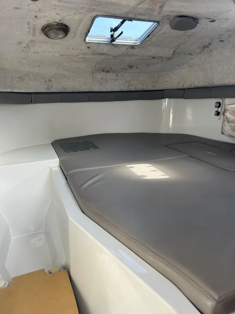 Slide: The Image of 2001 Glacier Bay Island Runner cabin interior with cushioned seating and overhead hatch. - 16