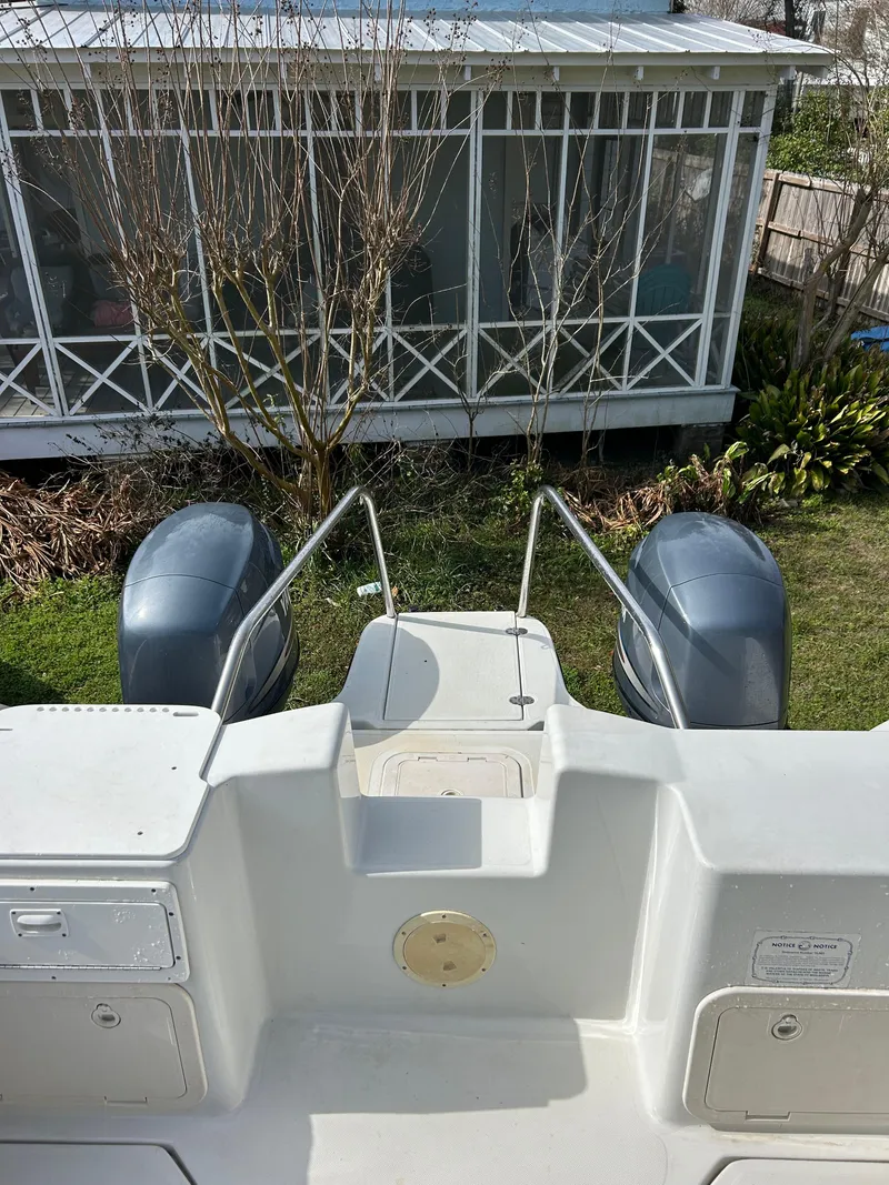 Slide: The Image of 2001 Glacier Bay Island Runner boat with dual engines, viewed from the deck, near a screened porch. - 5