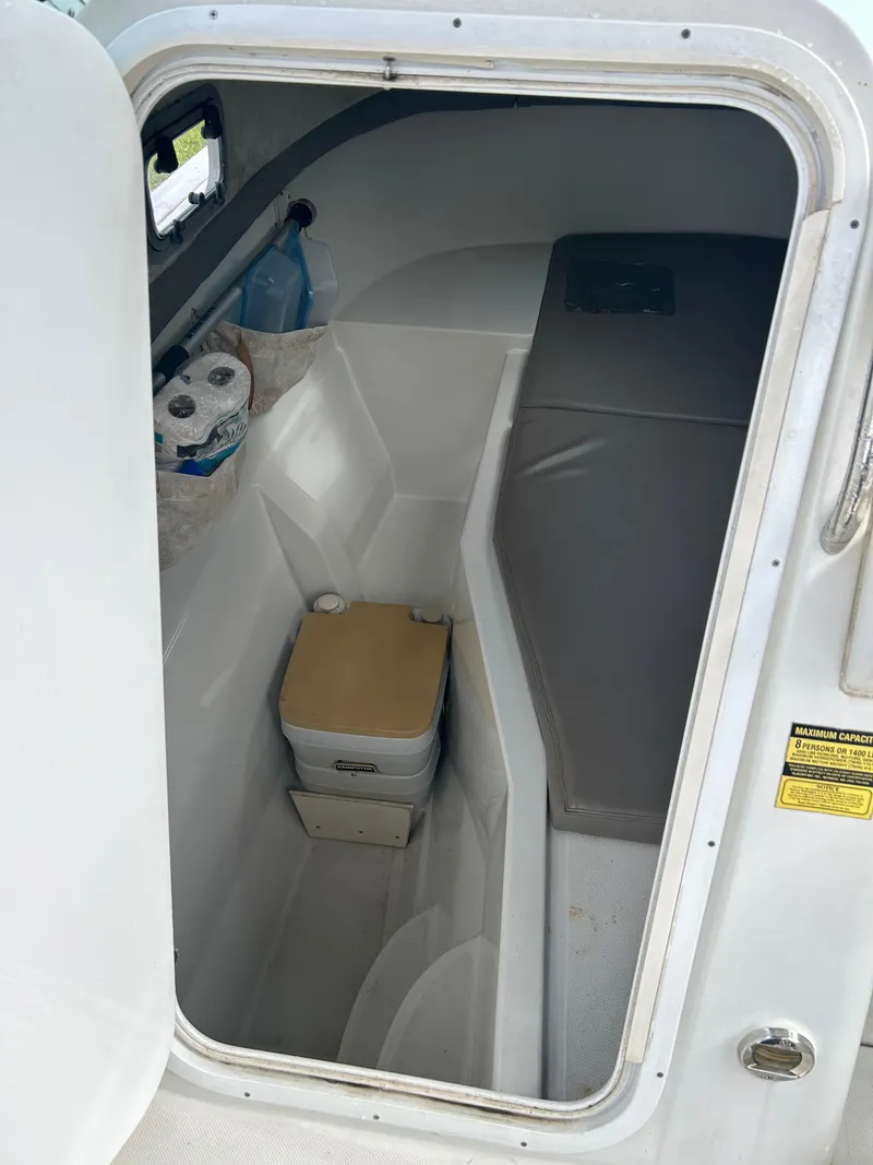 Slide: The Image of Interior cabin of 2001 Glacier Bay Island Runner boat with portable toilet and storage. - 9