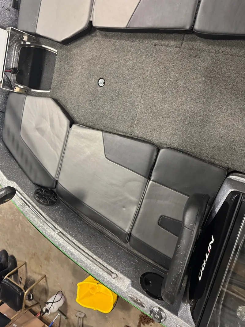 Slide: The Image of 2021 Nitro ZV19 Sport boat interior with gray seating and carpeted floor. - 17