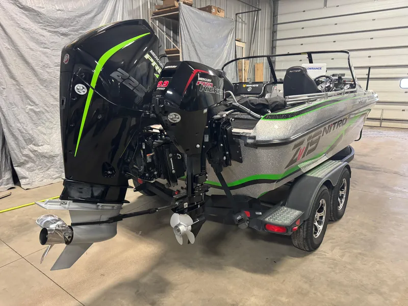 Slide: The Image of 2021 Nitro ZV19 Sport boat with powerful outboard motor in a garage setting. - 3