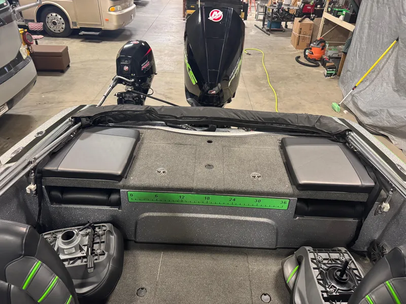 Slide: The Image of 2021 Nitro ZV19 Sport boat interior with dual motors in a garage setting. - 8