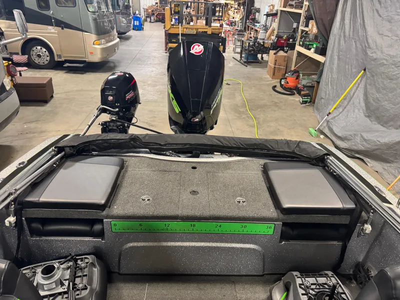 Slide: The Image of 2021 Nitro ZV19 Sport boat interior in a garage with visible outboard motors. - 9