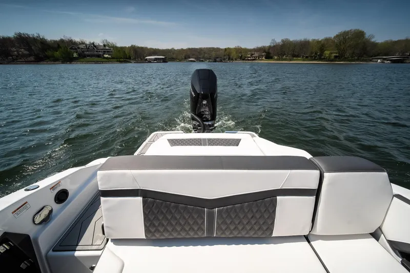 Slide: The Image of 2025 Monterey 275 SS Bowrider on a lake, showcasing rear seating and outboard motor. - 10