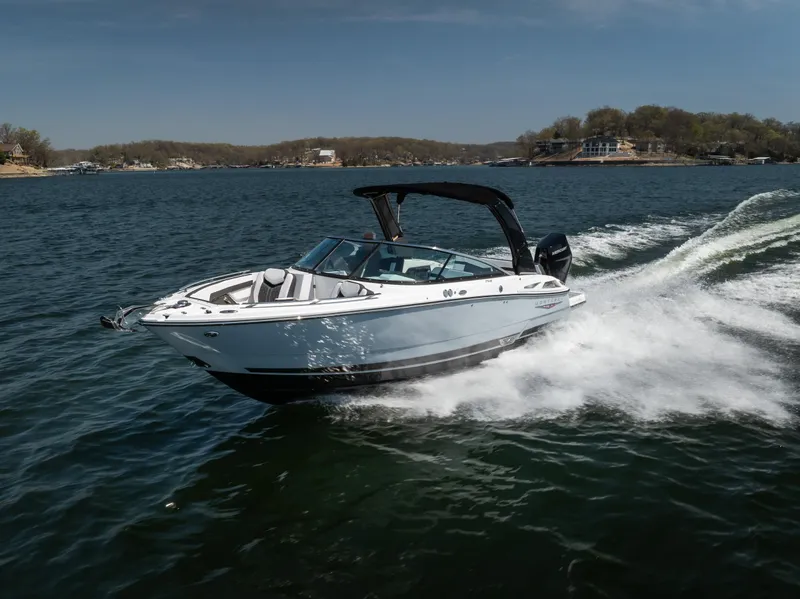 Slide: The Image of 2025 Monterey 275 SS Bowrider cruising on a lake under clear skies. - 2