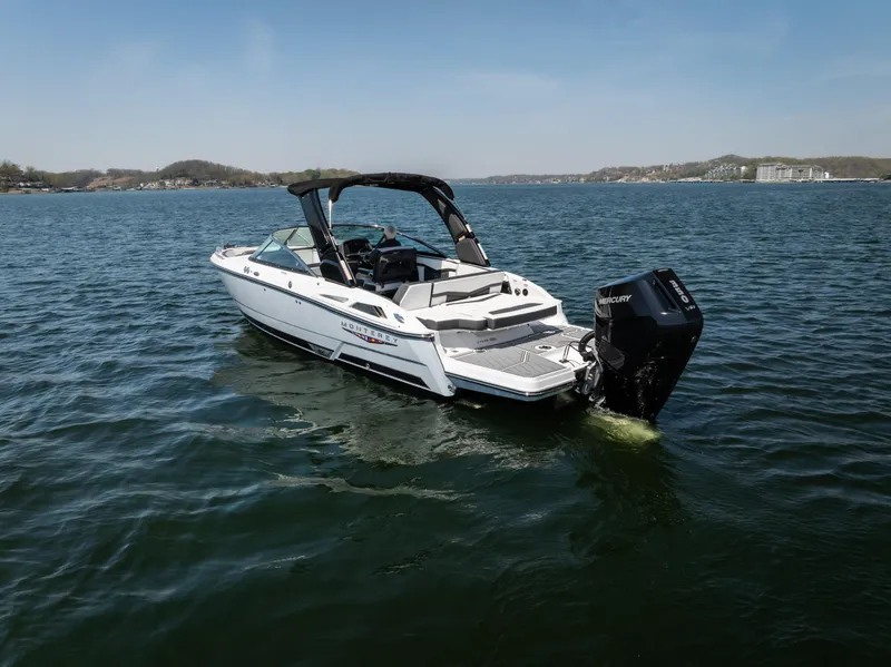 Slide: The Image of 2025 Monterey 275 SS Bowrider on a serene lake, showcasing sleek design and powerful engine. - 34