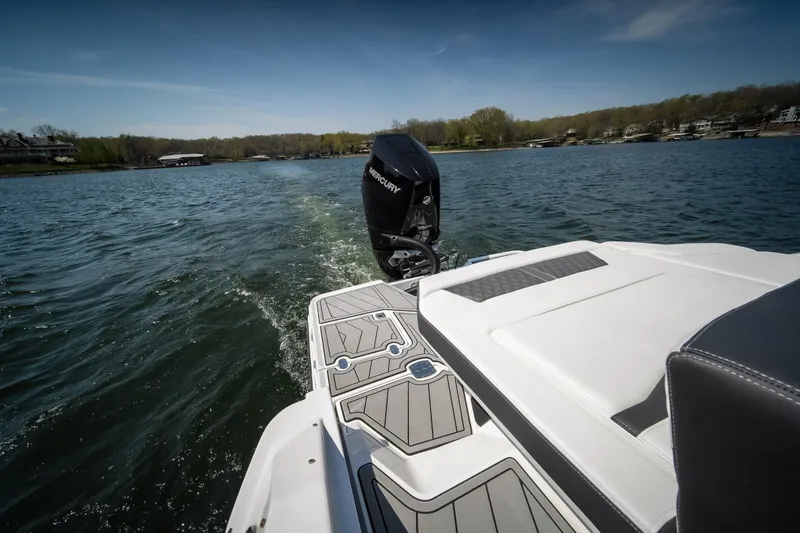 Slide: The Image of 2025 Monterey 275 SS Bowrider cruising on a scenic lake. - 11