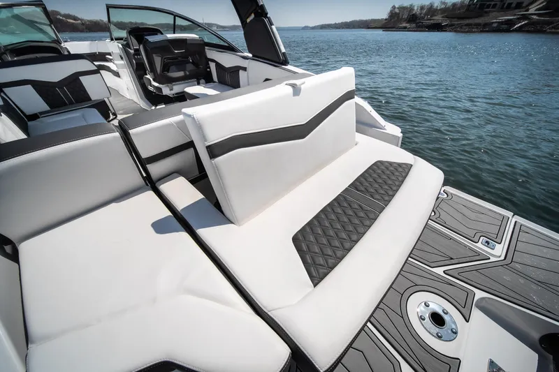 Slide: The Image of 2025 Monterey 275 SS Bowrider interior with sleek seating and modern design on a serene lake. - 17