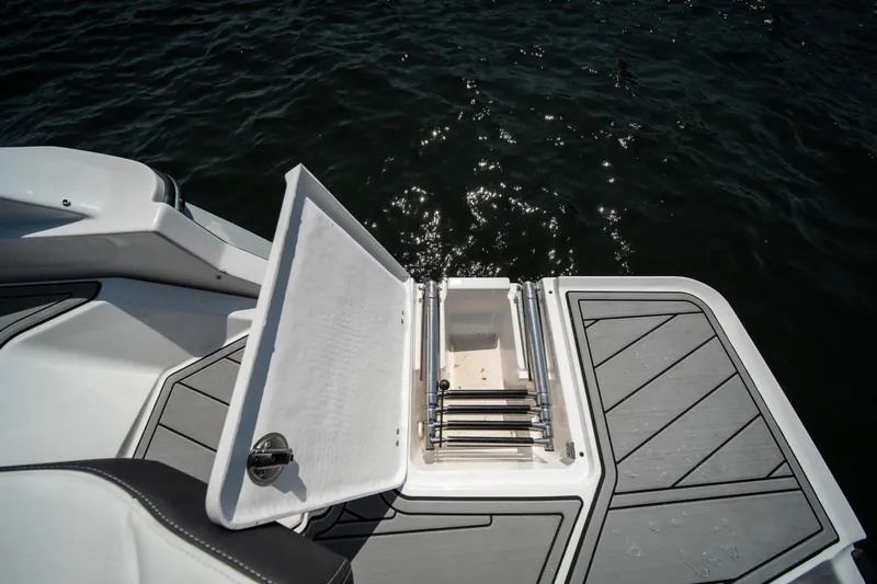 Slide: The Image of 2025 Monterey 275 SS Bowrider swim platform with ladder, open hatch, and water view. - 18
