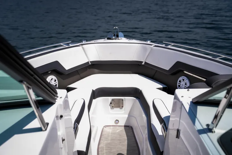 Slide: The Image of 2025 Monterey 275 SS Bowrider boat interior with seating, on calm water. - 19