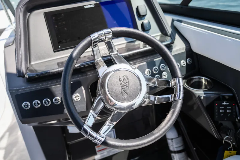 Slide: The Image of 2025 Monterey 275 SS Bowrider steering wheel and dashboard, featuring modern controls and sleek design. - 22
