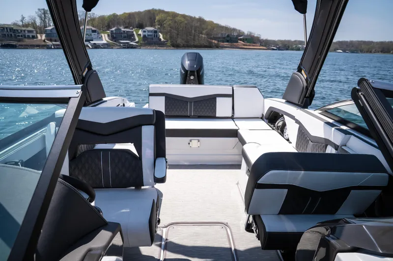 Slide: The Image of 2025 Monterey 275 SS Bowrider interior with luxurious seating on a sunny lake. - 26