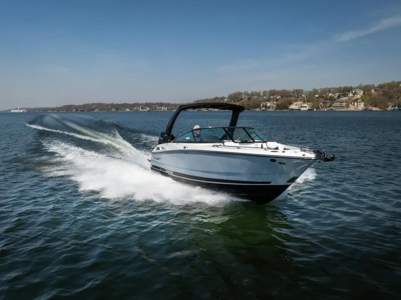 Slide: The Image of 2025 Monterey 275 SS Bowrider cruising on a lake under clear blue skies. - 31