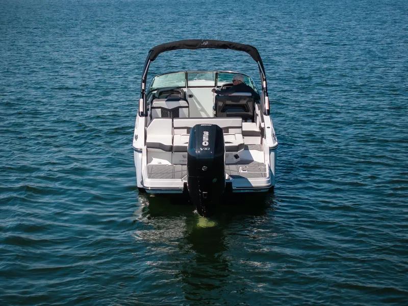 Slide: The Image of 2025 Monterey 275 SS Bowrider on calm blue water, rear view. - 32