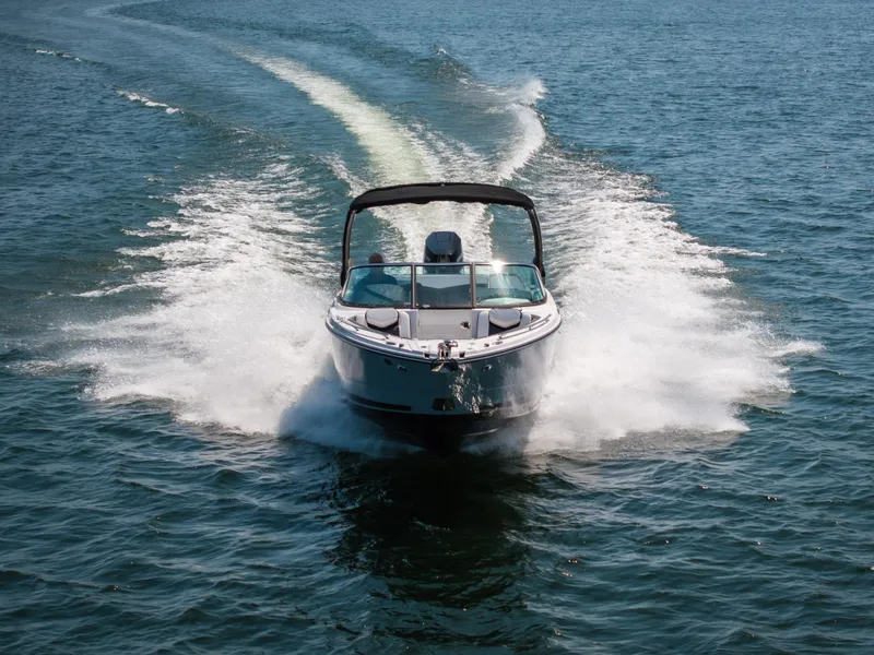 Slide: The Image of 2025 Monterey 275 SS Bowrider speeding on open water, creating a dynamic wake. - 36