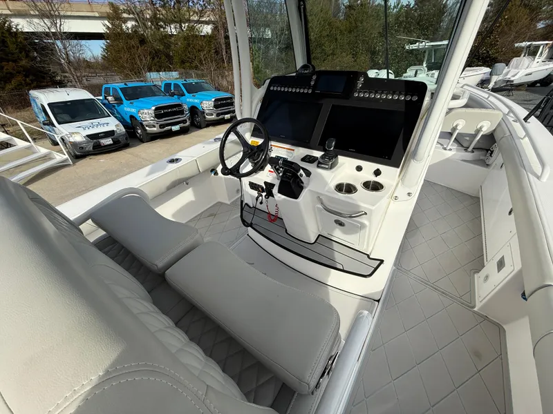 Slide: The Image of 2020 Everglades 273 Center Console boat interior with modern dashboard and seating. - 10