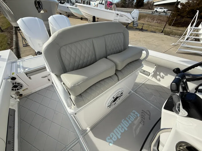Slide: The Image of 2020 Everglades 273 Center Console boat with cushioned seating and dual outboard motors. - 11