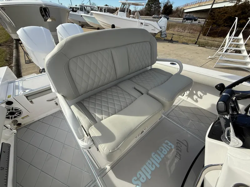 Slide: The Image of 2020 Everglades 273 Center Console boat with cushioned seating and sleek design. - 12