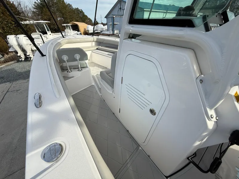Slide: The Image of 2020 Everglades 273 Center Console boat interior with seating and storage compartments. - 17