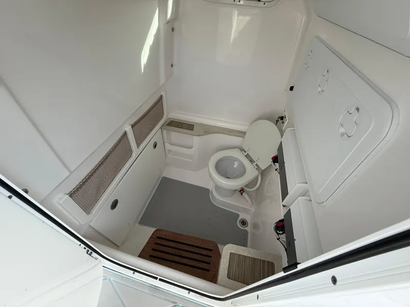 Slide: The Image of 2020 Everglades 273 Center Console boat interior with toilet and storage compartments. - 18