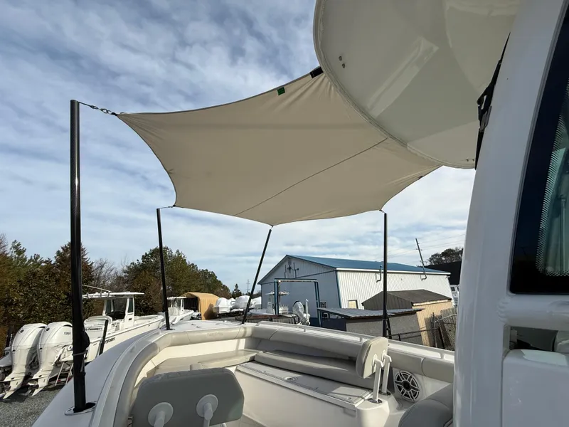 Slide: The Image of 2020 Everglades 273 Center Console boat with sunshade, docked outdoors. - 19