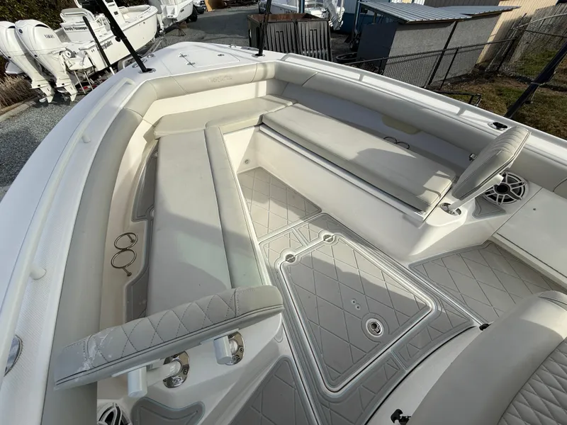 Slide: The Image of 2020 Everglades 273 Center Console boat interior with cushioned seating and storage compartments. - 21