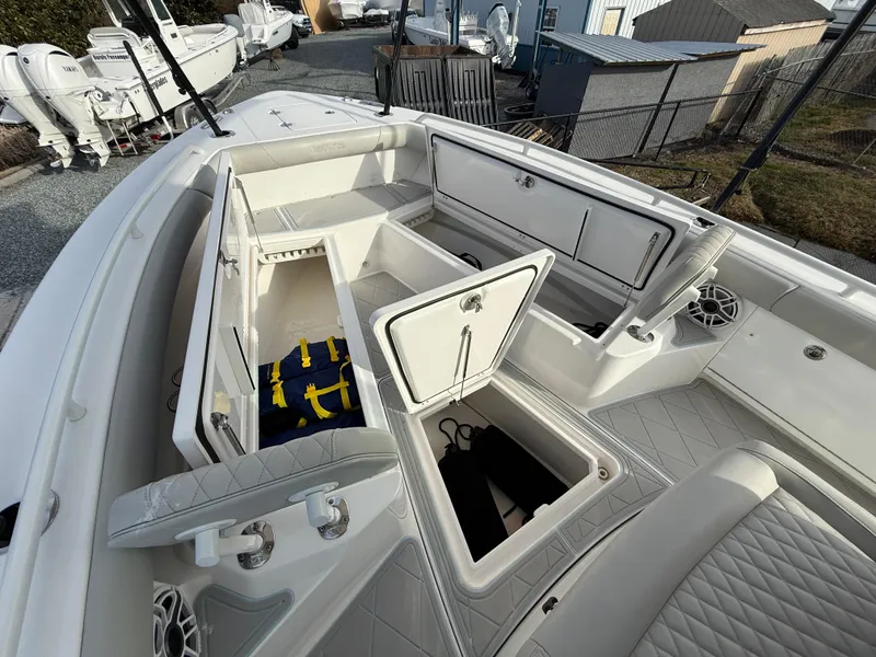 Slide: The Image of 2020 Everglades 273 Center Console boat with open storage compartments and seating. - 23