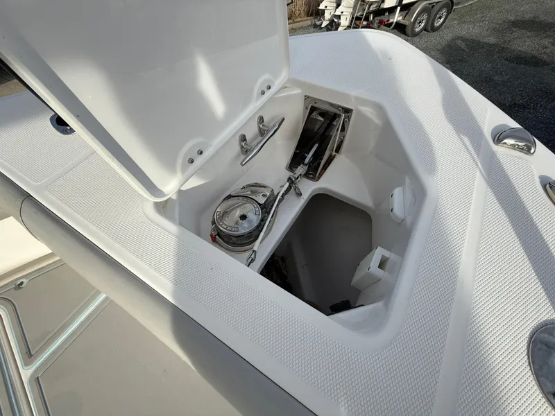 Slide: The Image of 2020 Everglades 273 Center Console anchor storage compartment open on deck. - 25