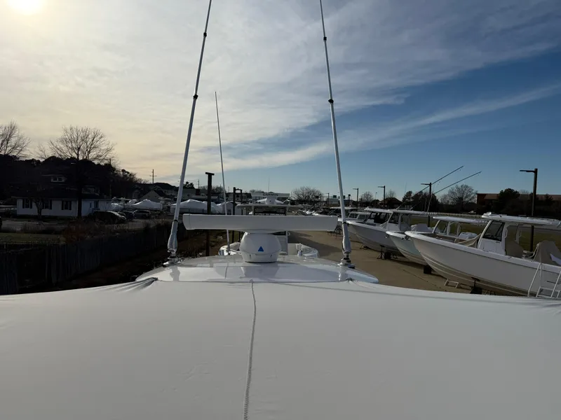 Slide: The Image of 2020 Everglades 273 Center Console boat docked under a cloudy sky. - 27