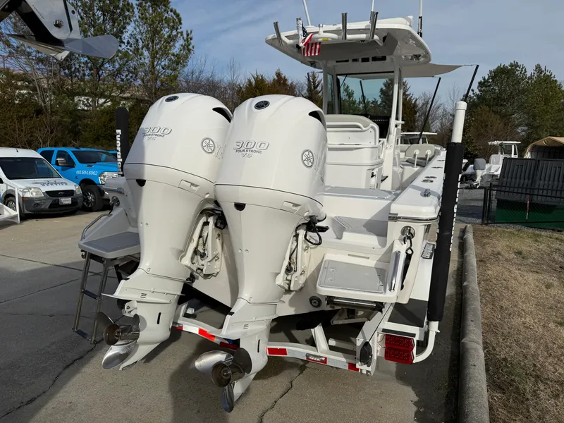 Slide: The Image of 2020 Everglades 273 Center Console boat with twin outboard engines, parked outdoors. - 3