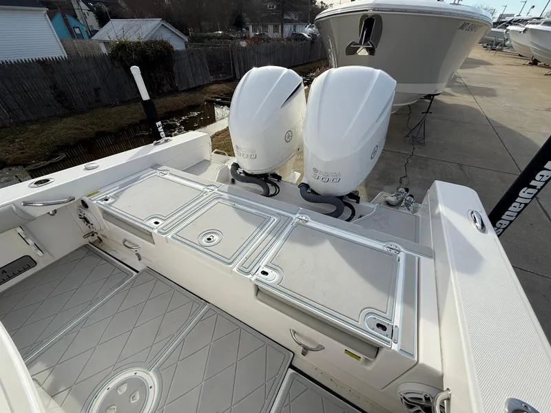 Slide: The Image of 2020 Everglades 273 Center Console boat with twin outboard engines, docked outdoors. - 6
