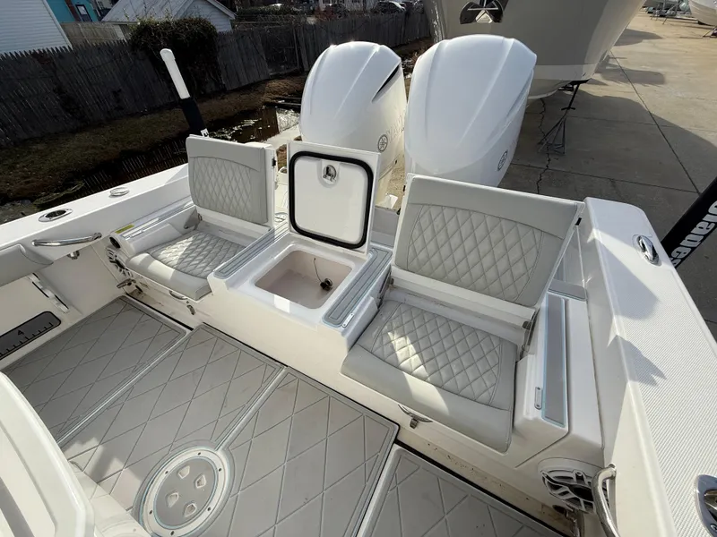 Slide: The Image of 2020 Everglades 273 Center Console boat interior with cushioned seating and storage compartments. - 7