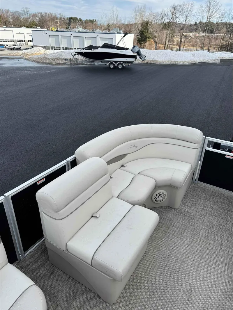 Slide: The Image of 2016 Bennington 22SLXP pontoon boat with beige seating on a snowy lot. - 12
