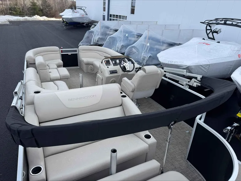 Slide: The Image of 2016 Bennington 22SLXP pontoon boat with beige seating, parked outdoors. - 6
