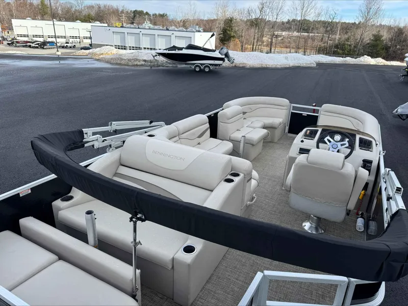 Slide: The Image of 2016 Bennington 22SLXP pontoon boat with beige seating, parked on asphalt near snow. - 7