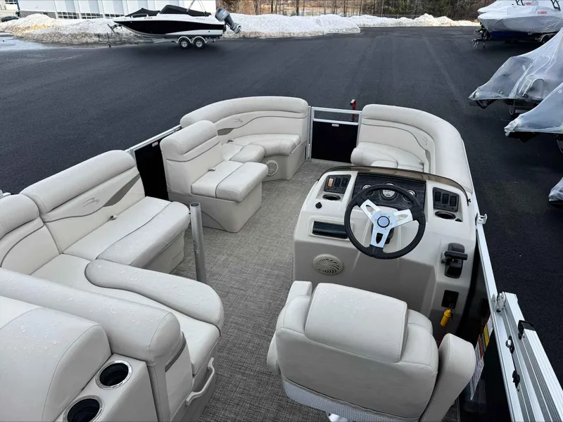 Slide: The Image of 2016 Bennington 22SLXP pontoon boat with beige seating and steering console. - 9