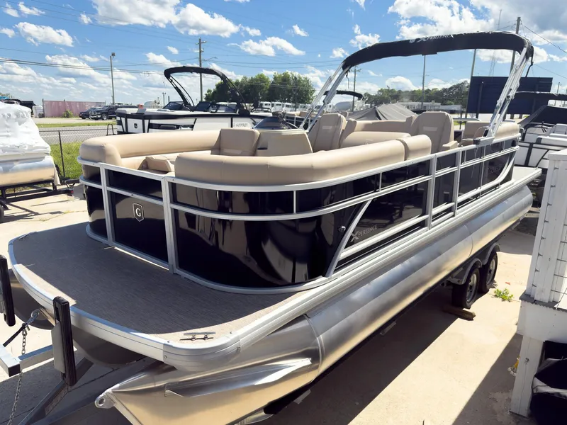 Slide: The Image of 2025 Godfrey Sweetwater Xperience 22' Tritoon with split bench, displayed outdoors. - 1
