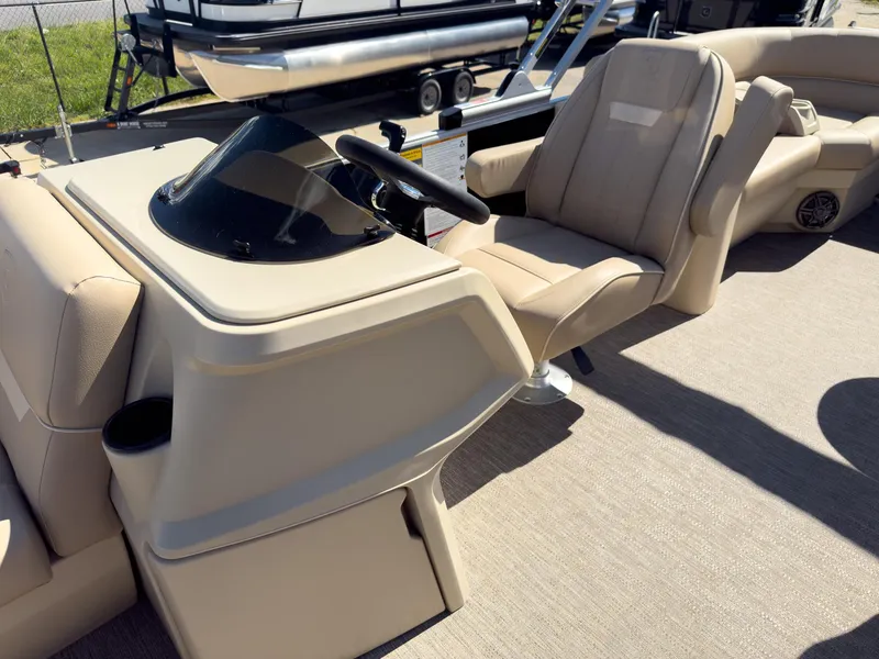 Slide: The Image of 2025 Godfrey Sweetwater Xperience 22' Tritoon helm with beige seating and steering console. - 12