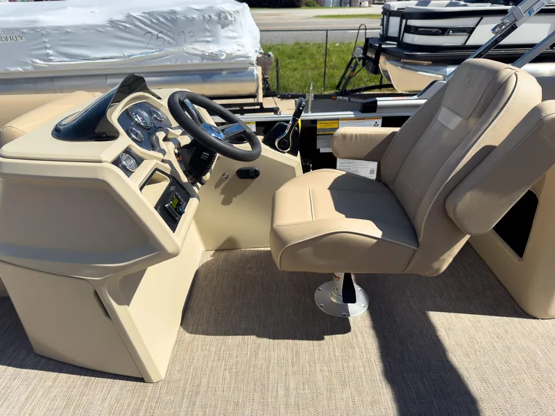Slide: The Image of 2025 Godfrey Sweetwater Xperience 22' Tritoon helm with beige captain's chair and steering console. - 13