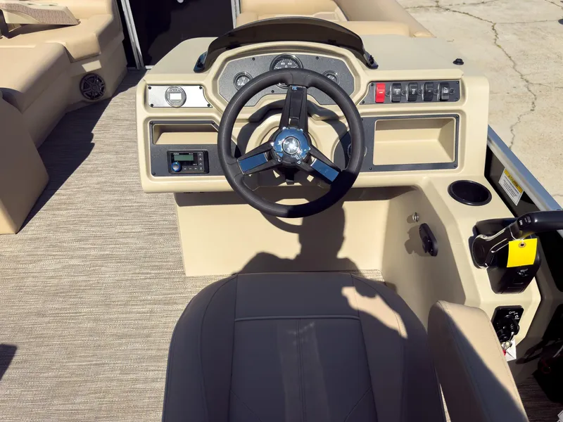 Slide: The Image of 2025 Godfrey Sweetwater Xperience 22' Tritoon helm with steering wheel and control panel. - 14