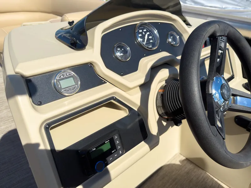 Slide: The Image of 2025 Godfrey Sweetwater Xperience 22' Tritoon dashboard with steering wheel and gauges. - 15